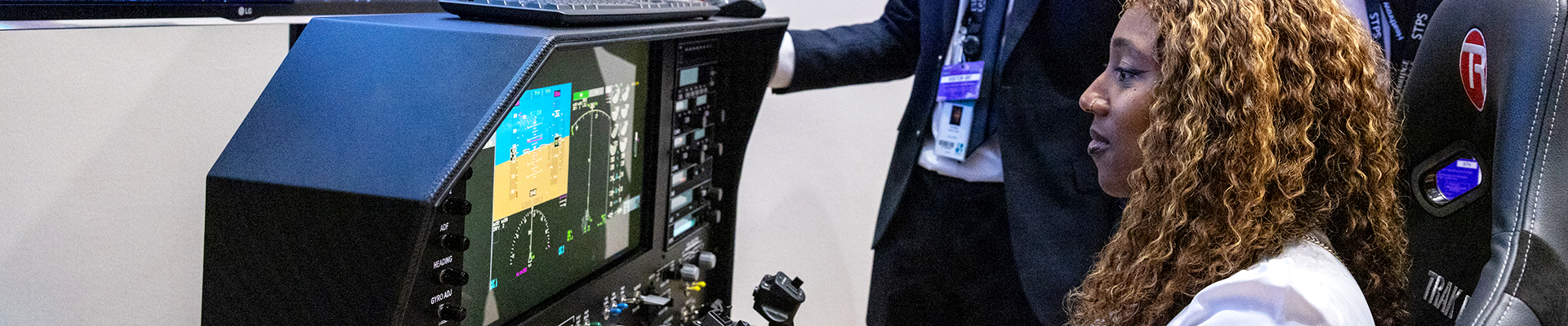 Female HRUC student using a flight simulator 