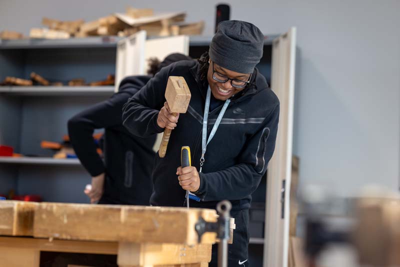 construction female student using mallet