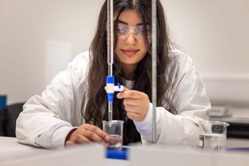 Science female student conducting experiment