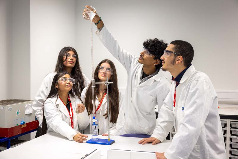 Science group of students conducting experiment